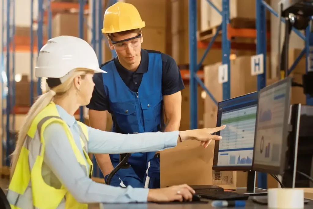 warehouse workers reviewing computer data