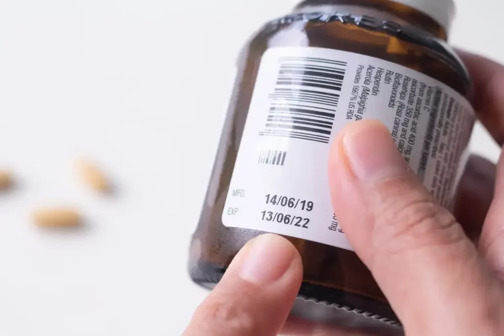 Closeup photo of an expiration date on a supplement bottle.