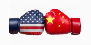 USA flag Vs China flag painting on boxing gloves on white background.