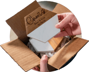 Customer removing a Personalized Wood and Marble Coaster from a box.
