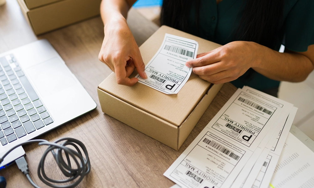 Warehouse employee placing a shipping label on a package